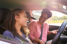 teenage girl in car with her parent