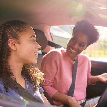 teenage girl in car with her parent