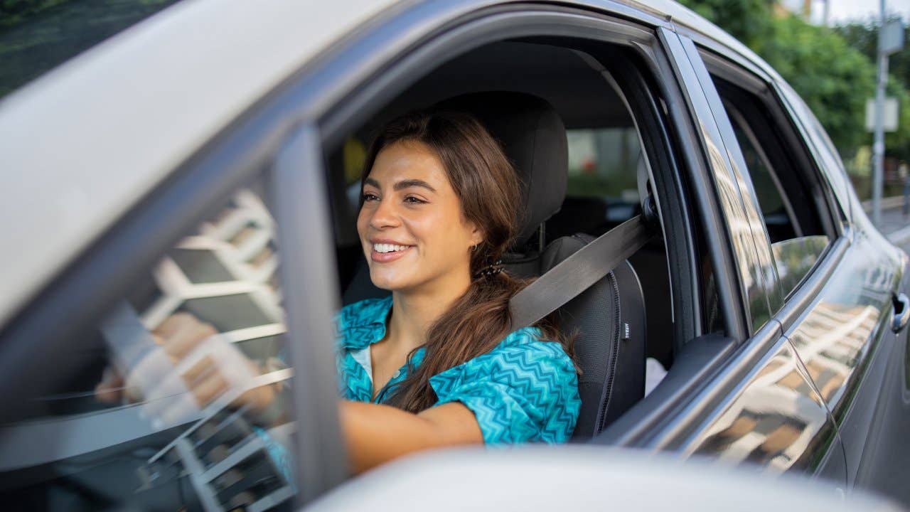 Woman is driving a car on her way to work