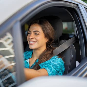 Woman is driving a car on her way to work