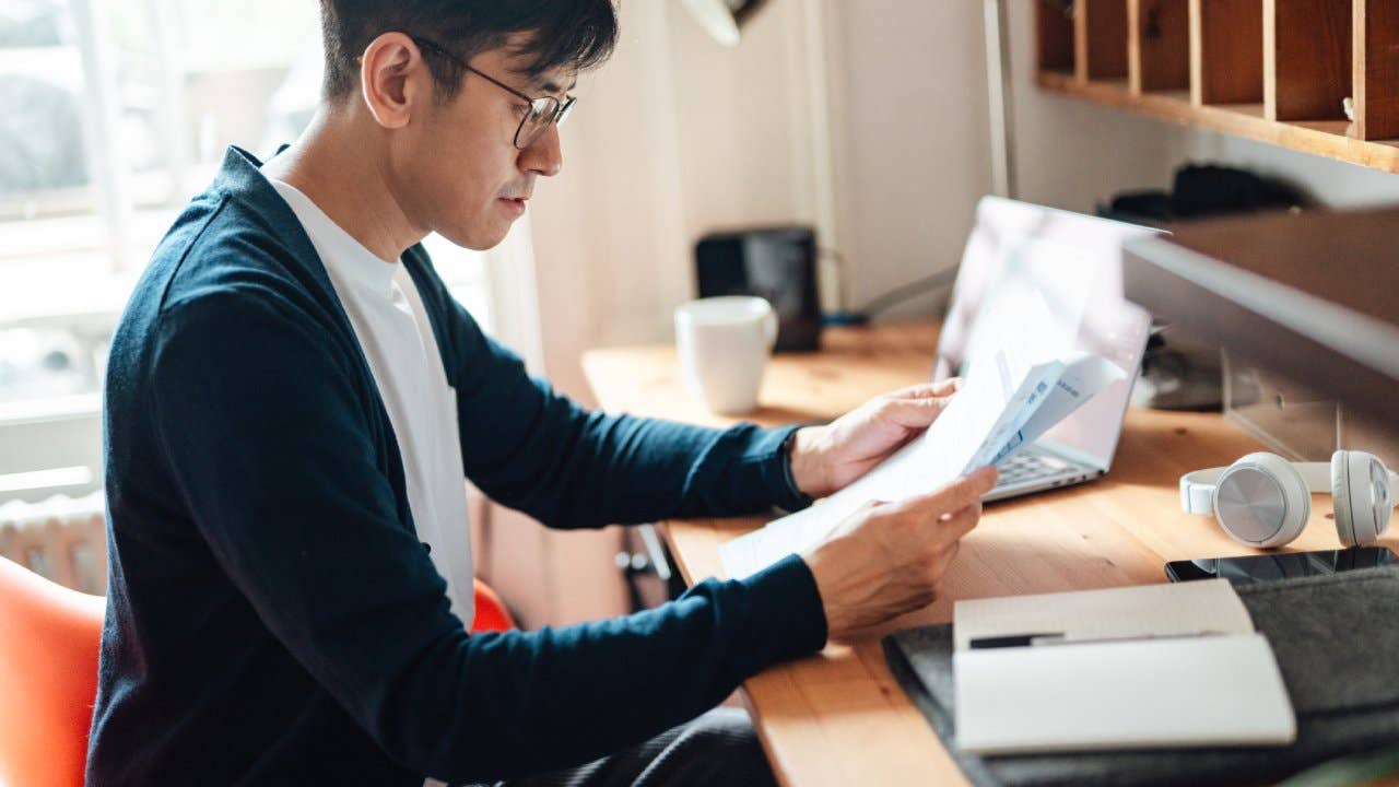 Young man looking at financial bills