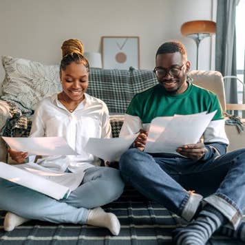 Young smiling couple going over bills