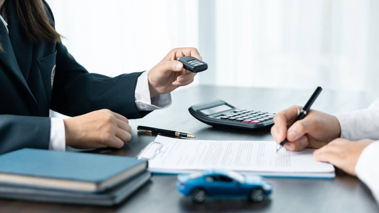 car saler or sales manager offers to sell a car