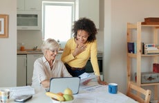 older and younger woman working on financials