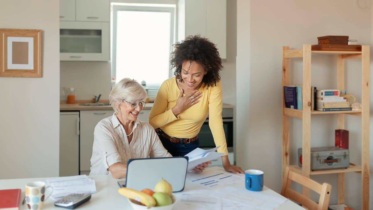 older and younger woman working on financials