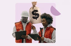 Black man and woman standing, holding clipboards in construction vests.