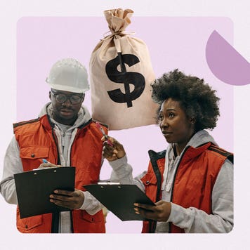 Black man and woman standing, holding clipboards in construction vests.
