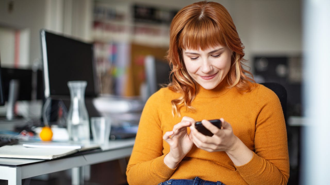 Businessman using her mobile phone in office