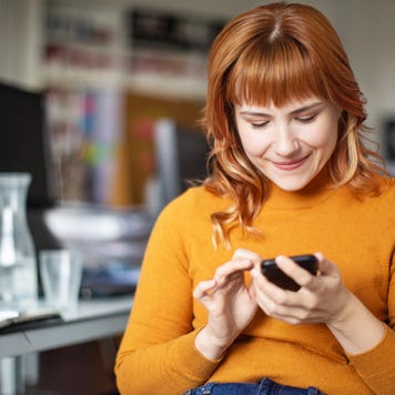 Businessman using her mobile phone in office