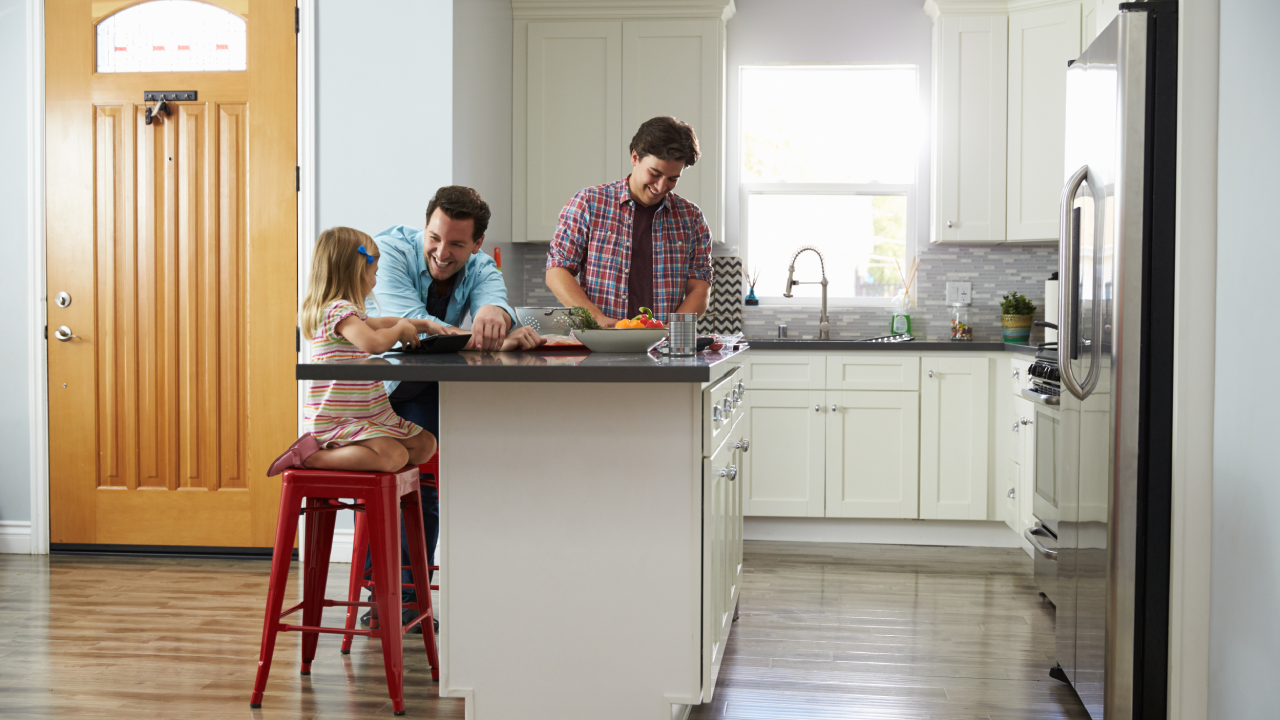 a couple and their child in their kitchen of their new home