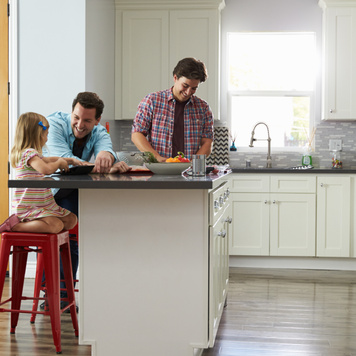 a couple and their child in their kitchen of their new home