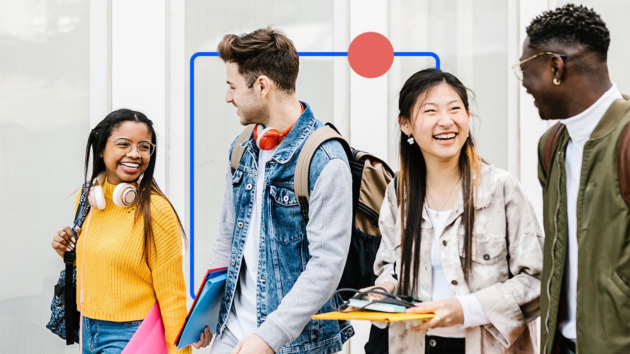 Young college students laughing and walking between classes