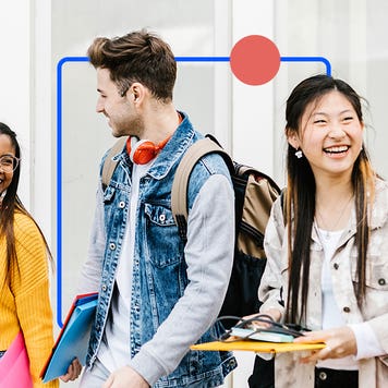 Young college students laughing and walking between classes