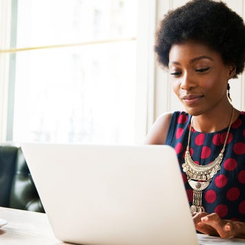 Woman using laptop at table