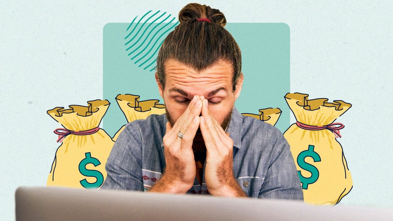 A person sitting in front of a laptop computer, their hands on their face expressing frustration.