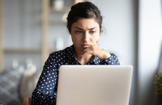 woman read email on laptop feels concerned