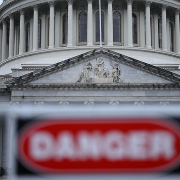 U.S. capital building with a blurry DANGER sign in front