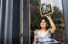 small business owner turning open sign in her store