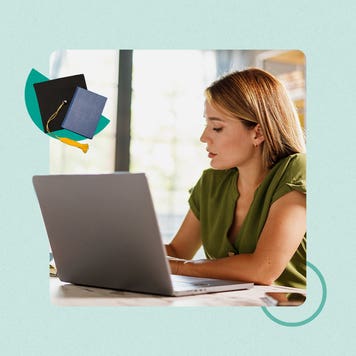 A woman looks at a laptop.