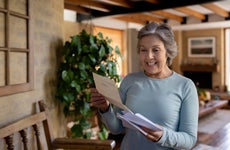 Senior woman looking happy about getting a letter in the mail