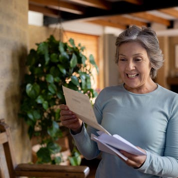 Senior woman looking happy about getting a letter in the mail