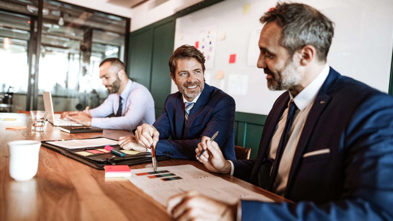 Businessmen talking around a meeting table