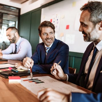 Businessmen talking around a meeting table