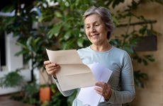 An older American woman receives a letter in the mail