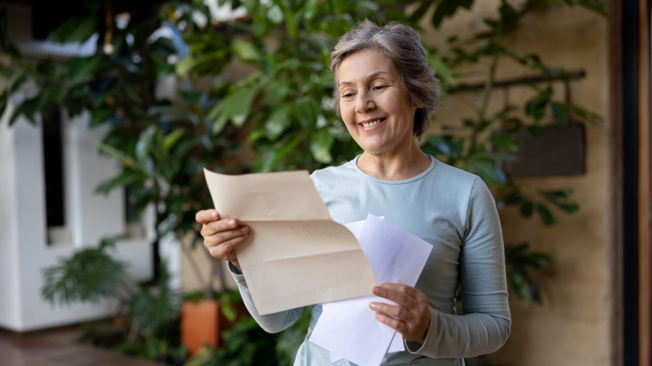 An older American woman receives a letter in the mail
