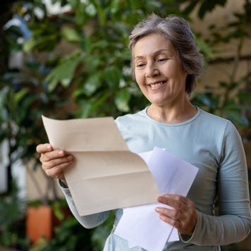 An older American woman receives a letter in the mail