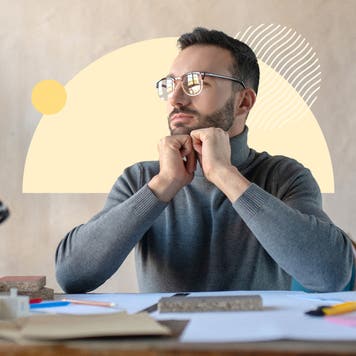 Man with glasses sitting at a desk