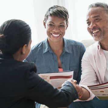 couple talking to businesswoman