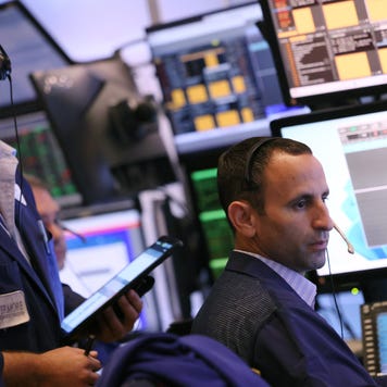 Traders work on the floor of the New York Stock Exchange