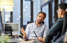 coworkers discussing during meeting in office