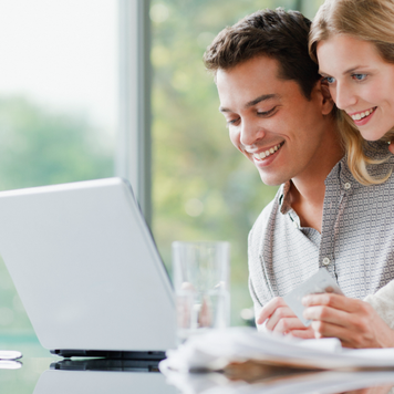 Couple shopping online with credit card