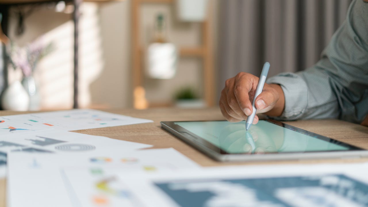 Young man using pen and tablet