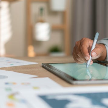 Young man using pen and tablet