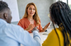 Young businesswoman giving financial advice to couple