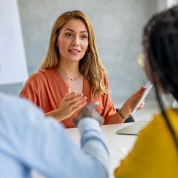 Young businesswoman giving financial advice to couple