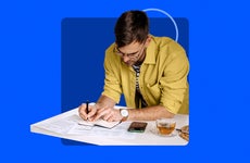 man working on financial paperwork, blue background