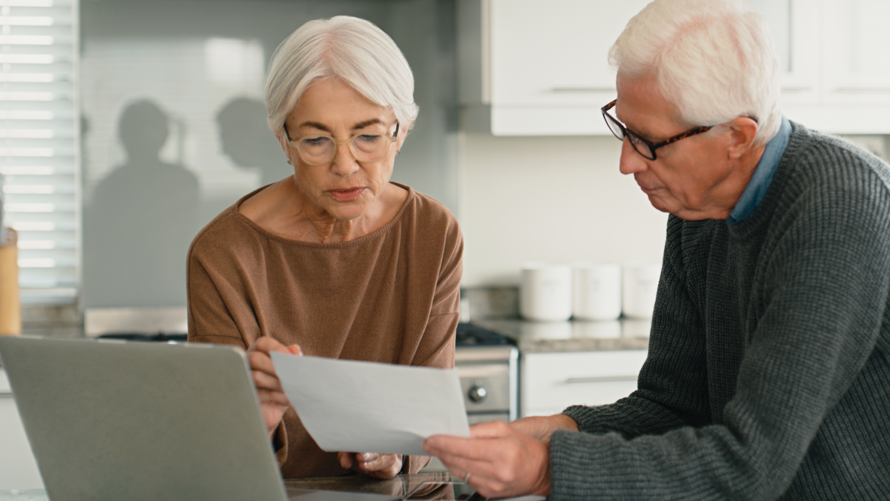 Senior couple, finance documents and computer for home mortgage, budget planning and pension or bills. Elderly woman and man on laptop, reading paperwork and asset management, loan or life insurance