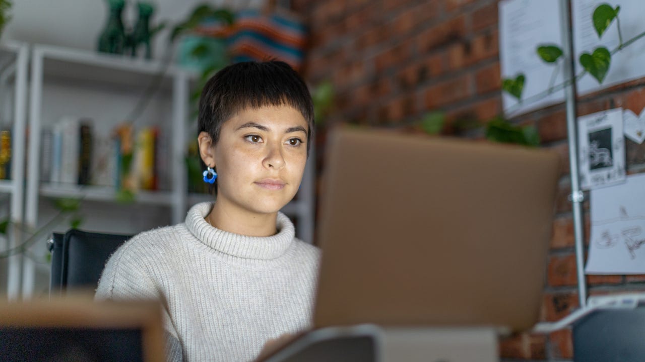 Young businesswomen speaking to colleagues on a video call