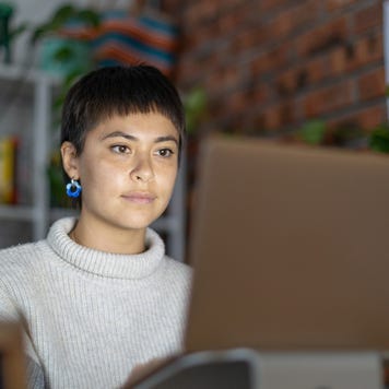 Young businesswomen speaking to colleagues on a video call