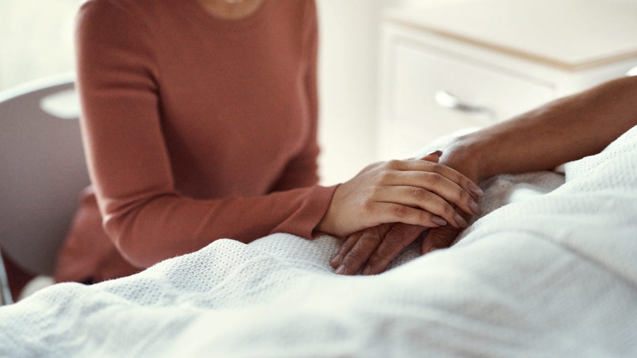 healthcare and support with a woman holding hands with her man in the hospital