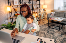 Mother with baby working in office at home