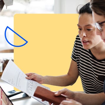 Two people reviewing paperwork