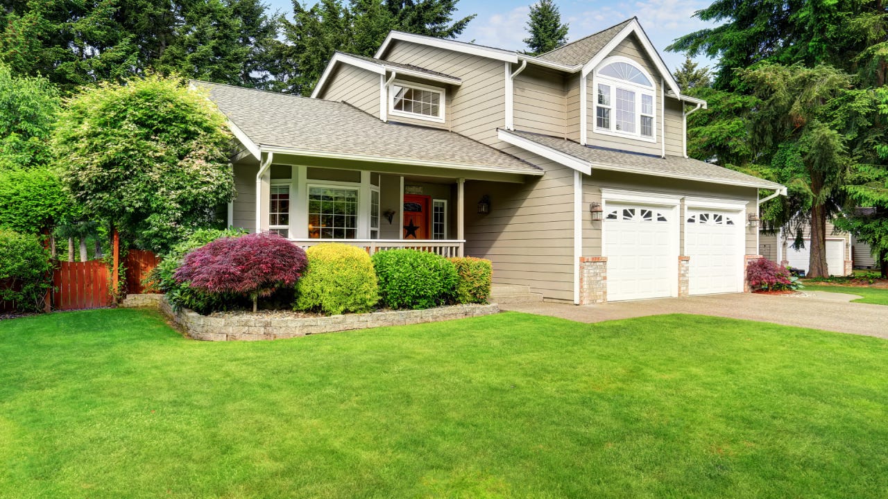 American house exterior with double garage and well kept lawn