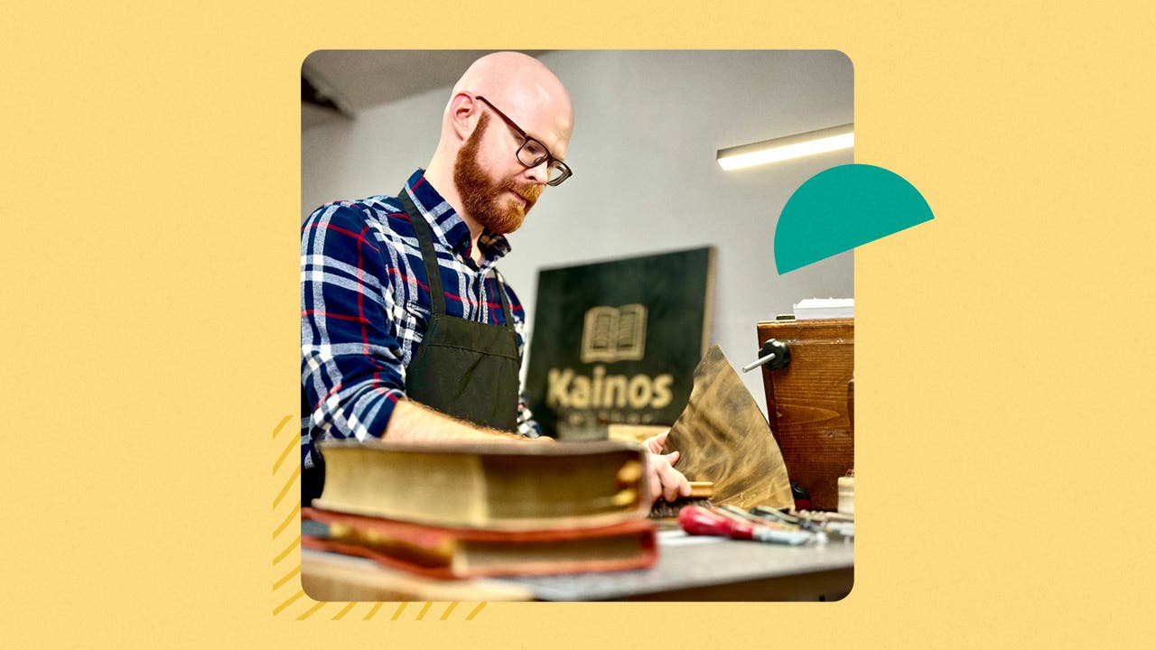 Kaleb George binding books in his studio.