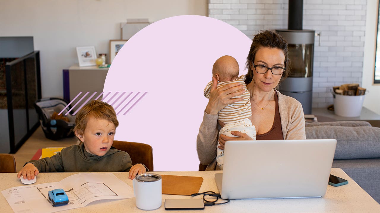 A mom tending to children while also working on a laptop