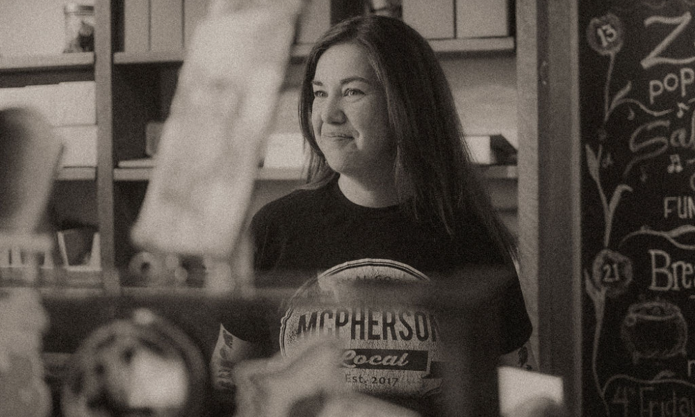 Black and white photo of Jen McPherson overlooking her store